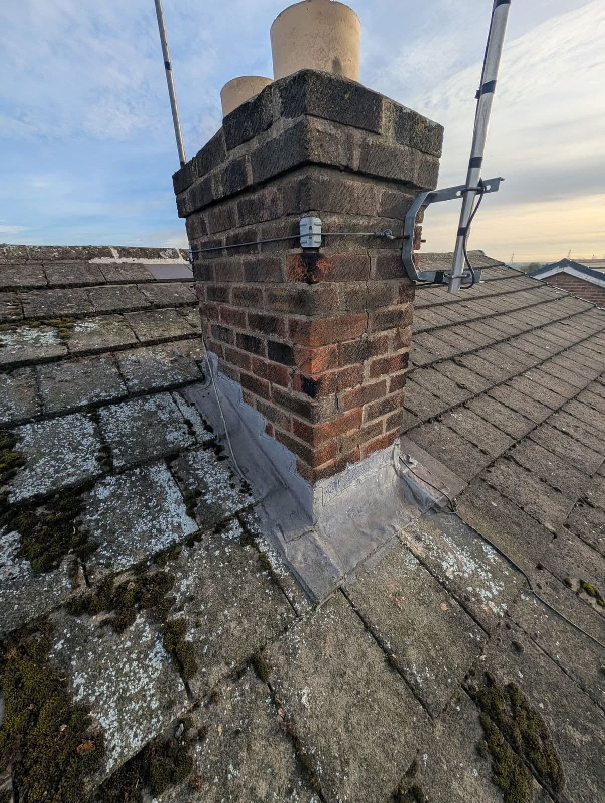 Chimney and mossy tiles before repair