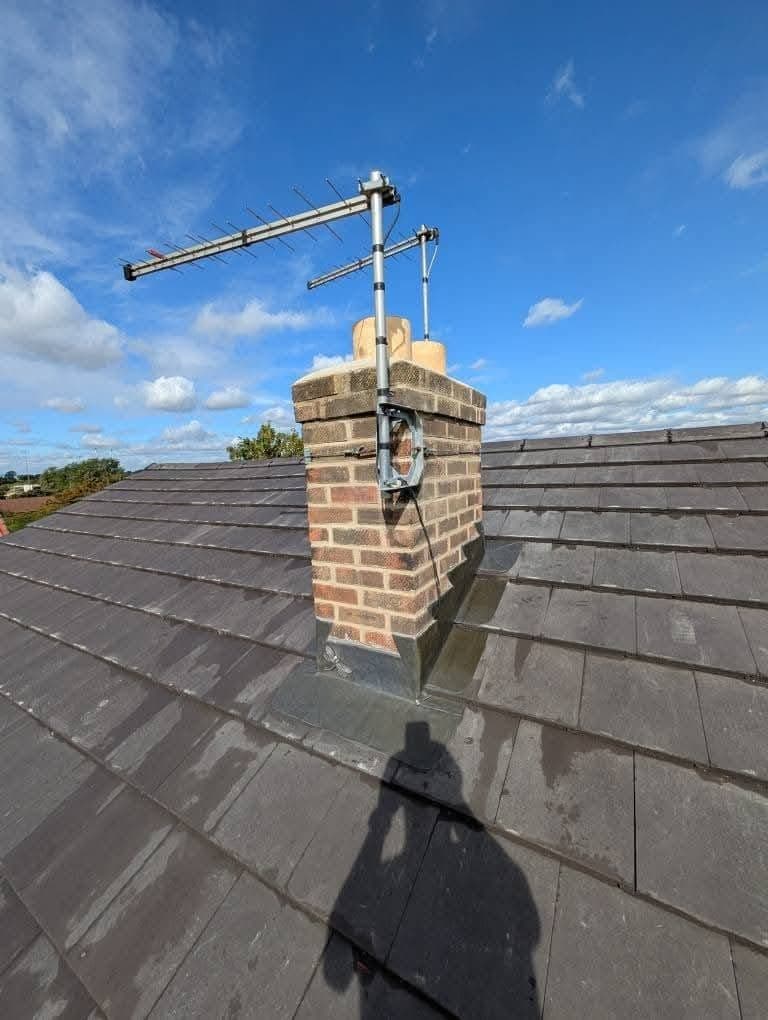 Chimney stack with new lead flashing on a re-roofed bungalow