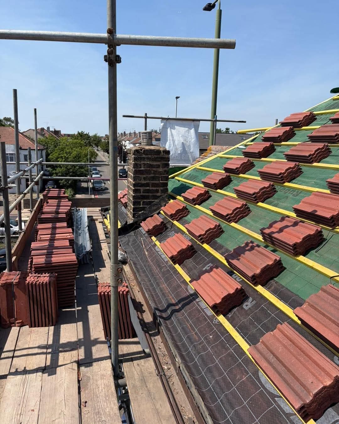 Re-roof with clay tiles being loaded out