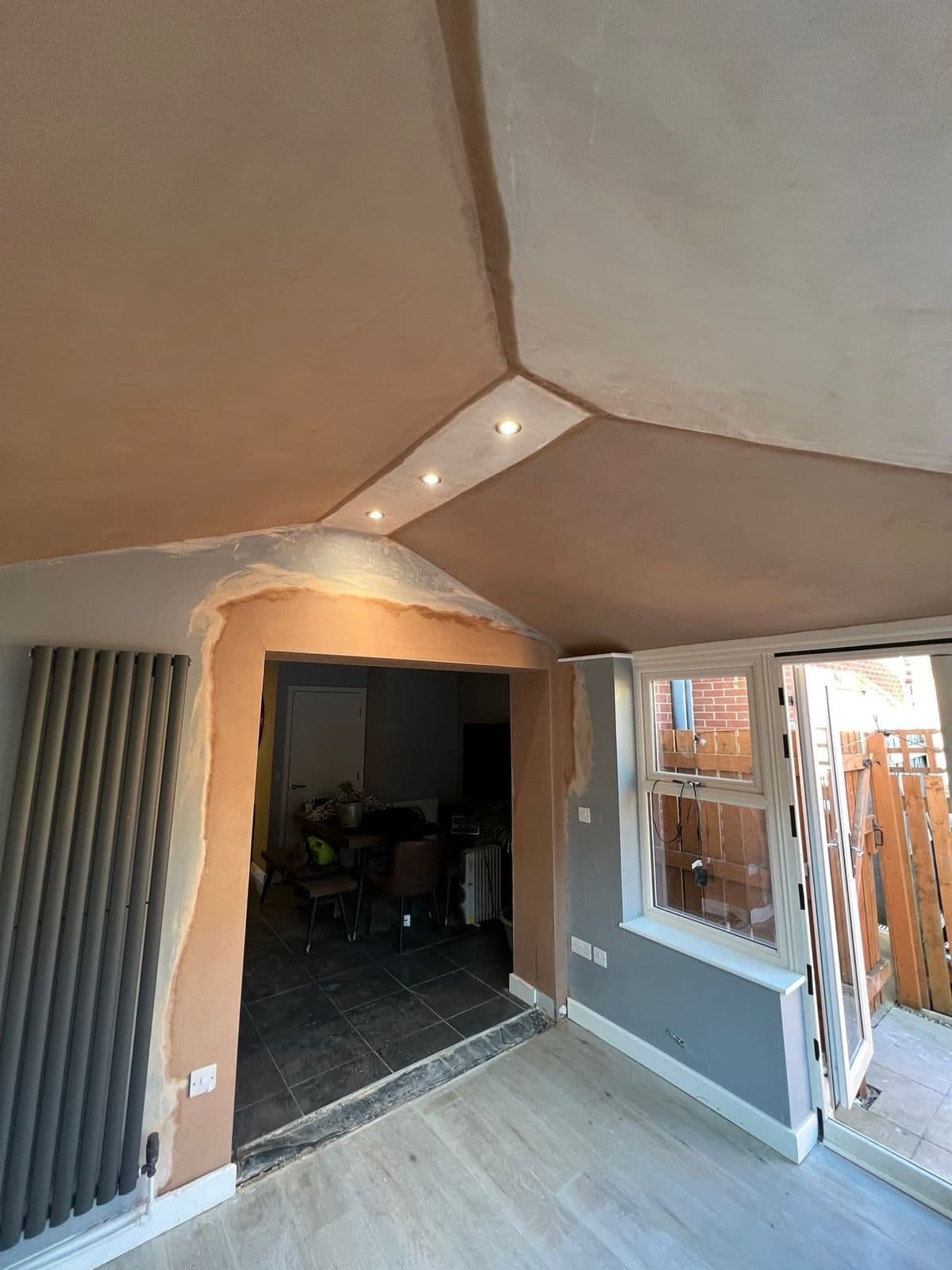 Inside a converted conservatory: plastered ceiling with downlights