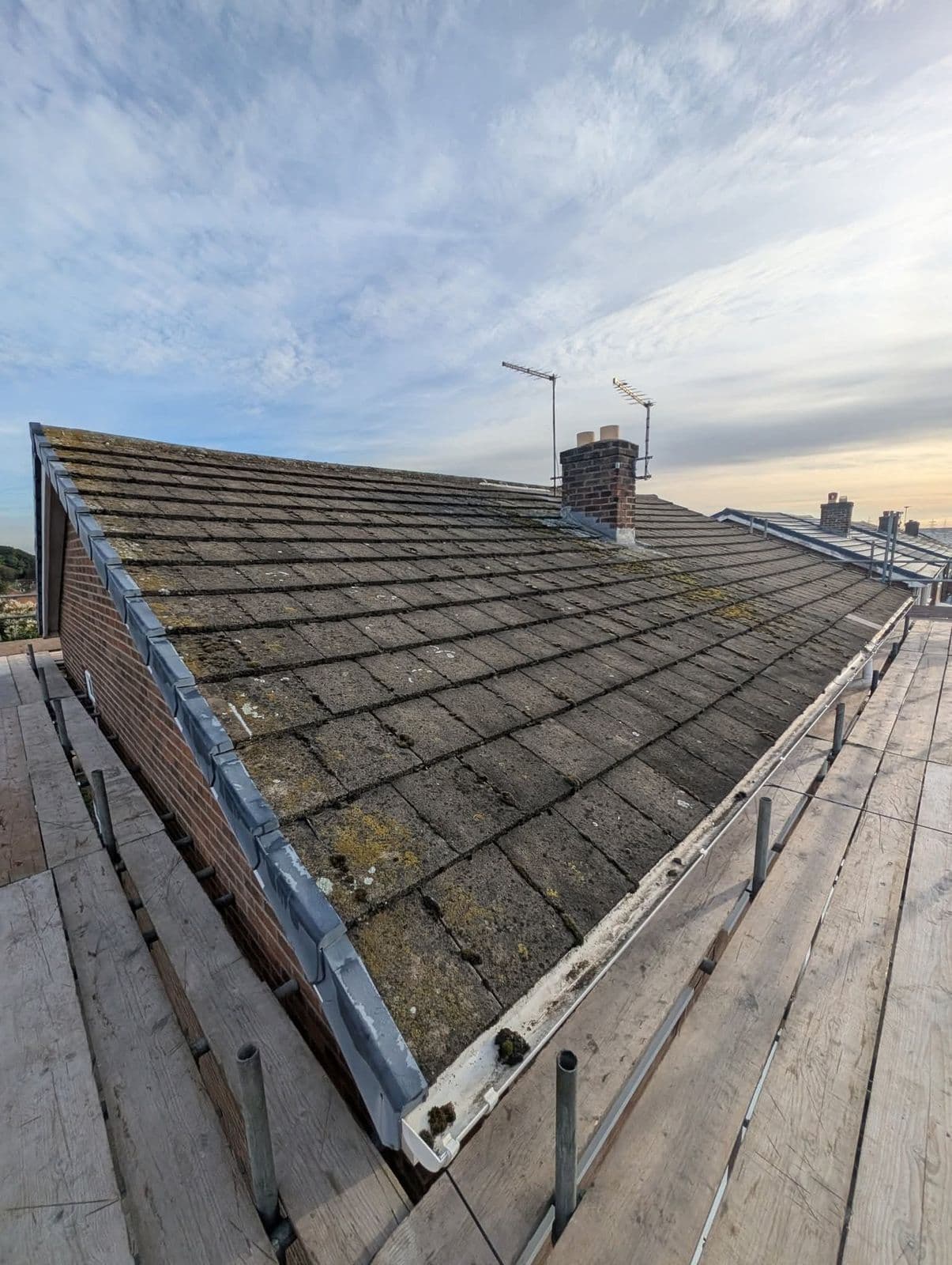 Mossy concrete tile roof before re-roofing