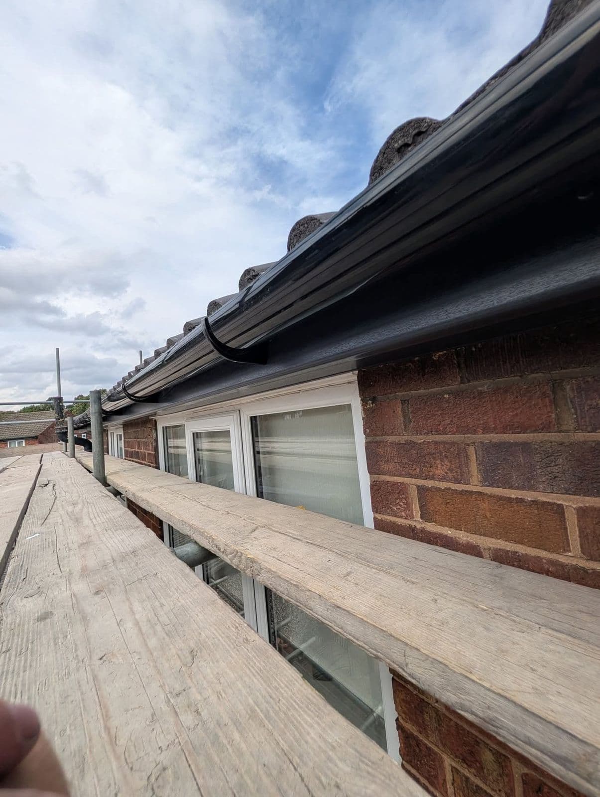 New fascia and black guttering fitted along the eaves