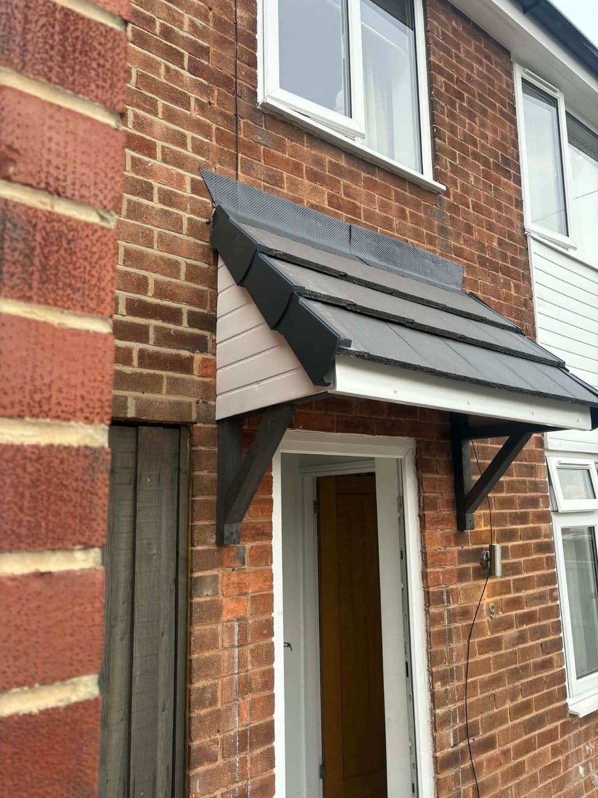 New tiled porch canopy over a front door