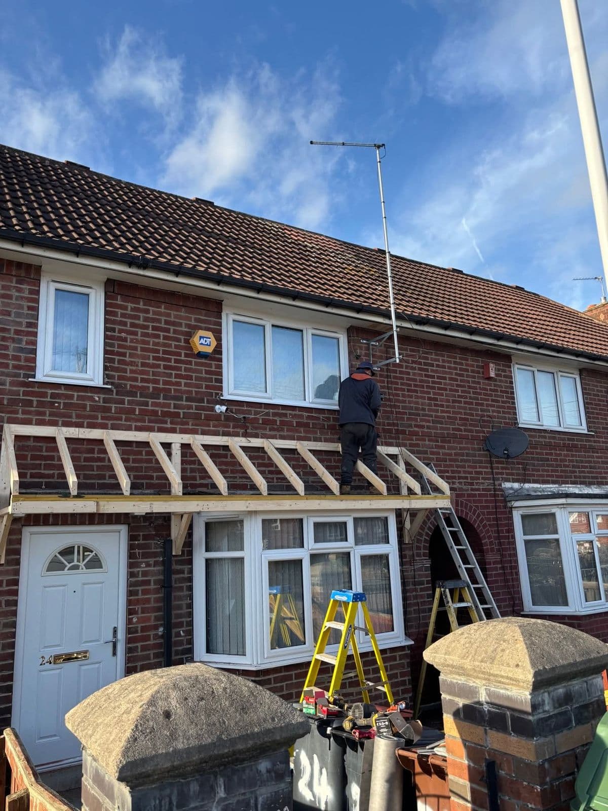 Porch canopy frame being built