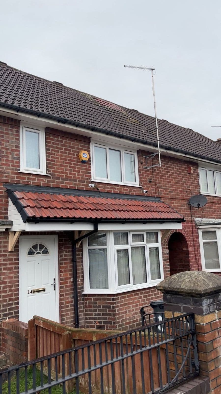 Terraced house with a tiled porch canopy