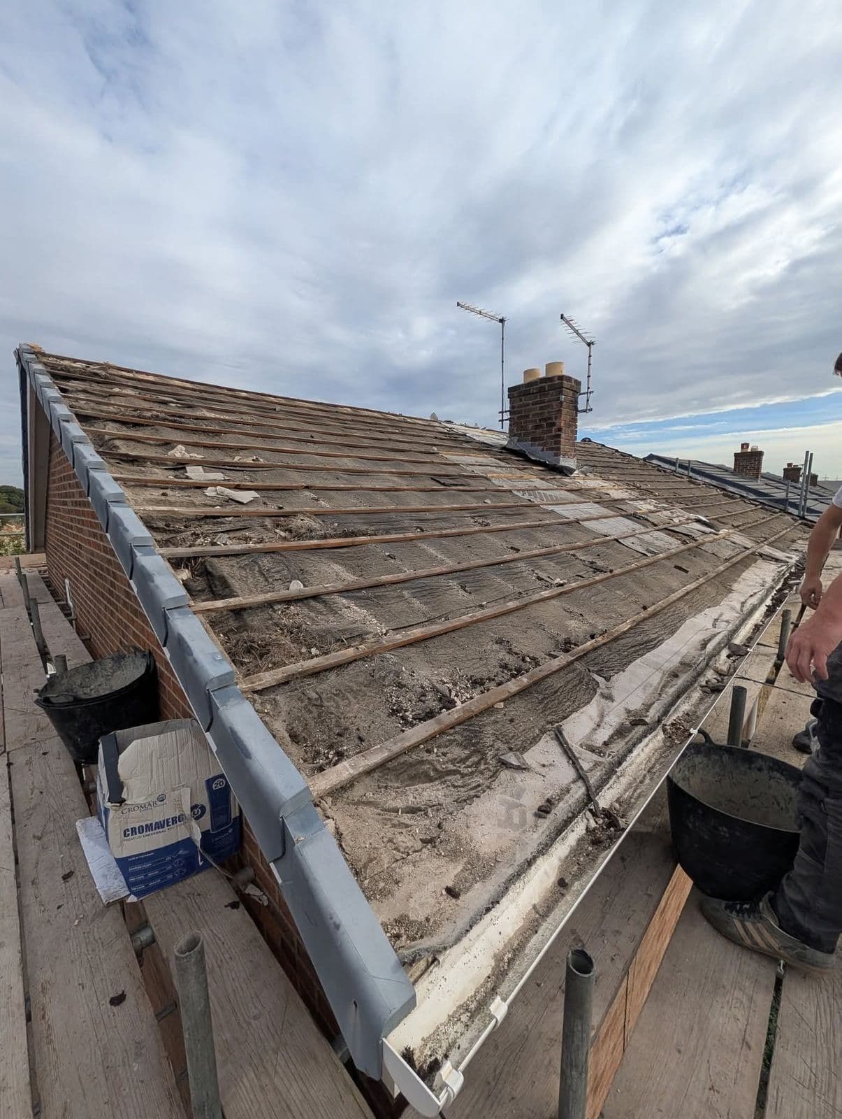 Worn tiled roof before stripping